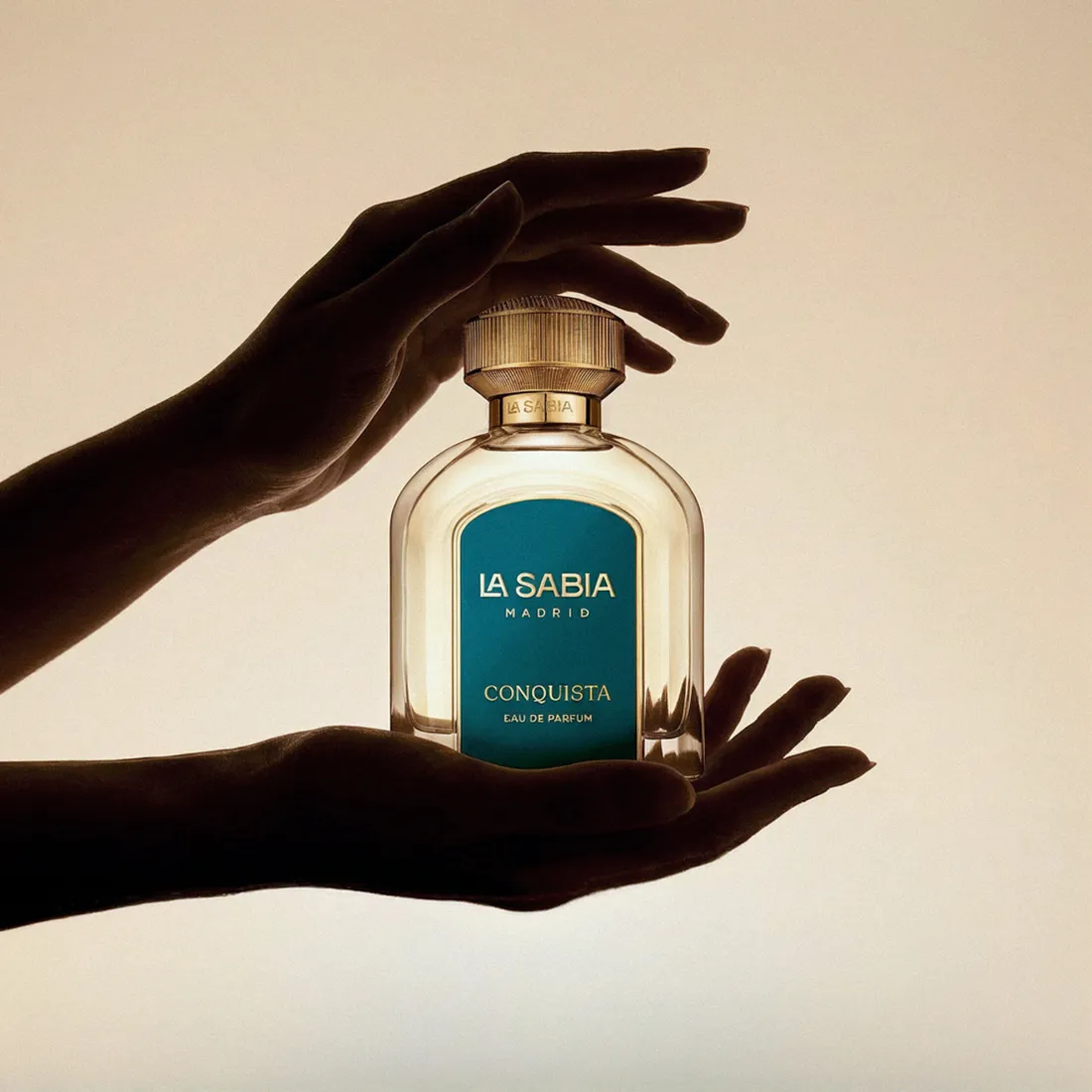 A fragrance cradled in a hand under soft light · TimeLäB Studio