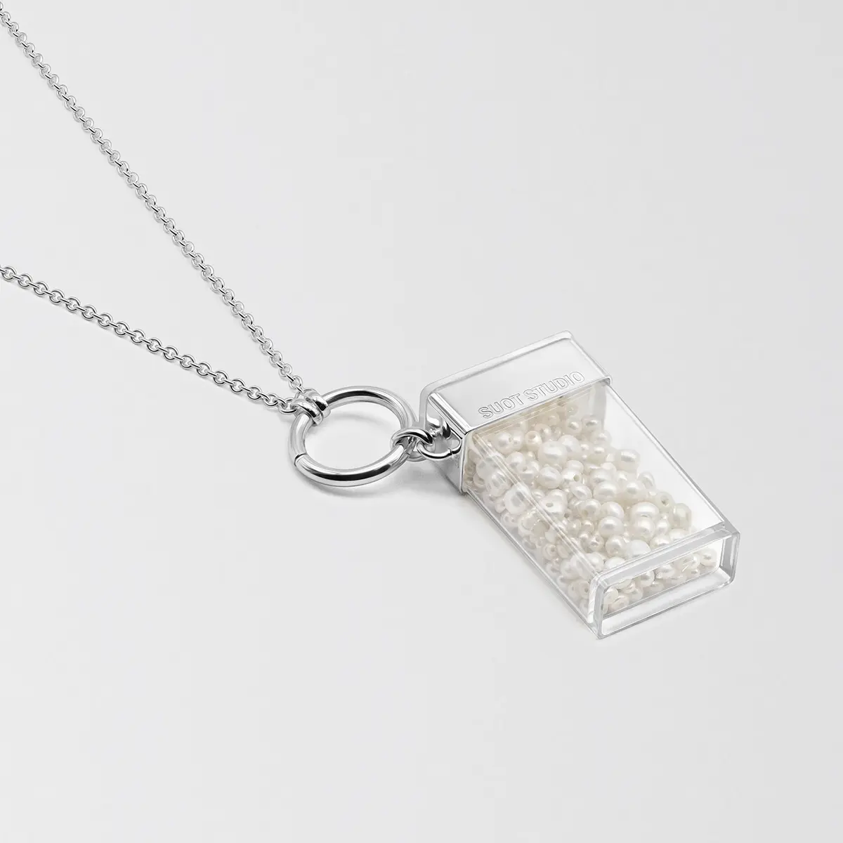 Silver necklace holding a clear vial pendant · Jewellery photography, TimeLäB Studio Barcelona