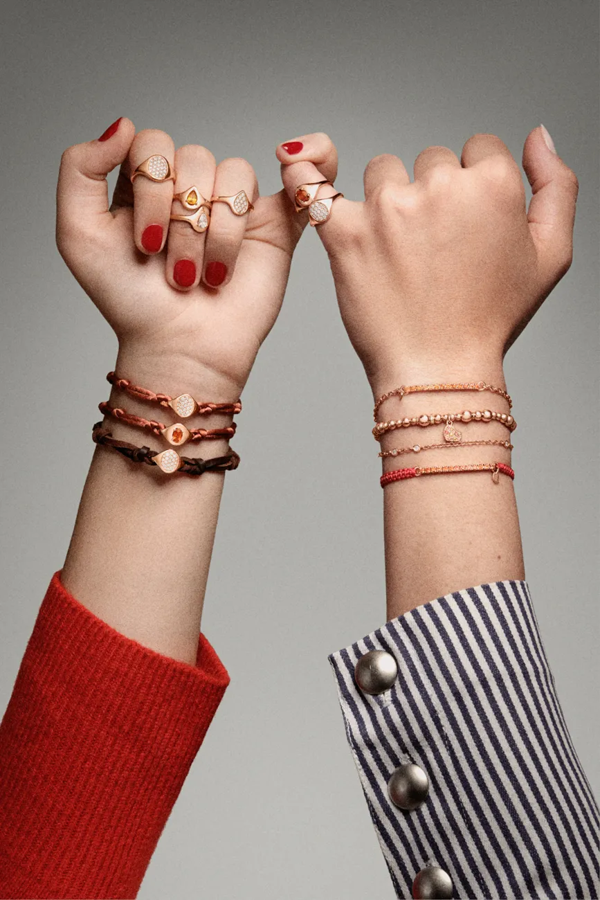 Two wrists with red string and charm bracelets · Jewellery photography, TimeLäB Studio Barcelona