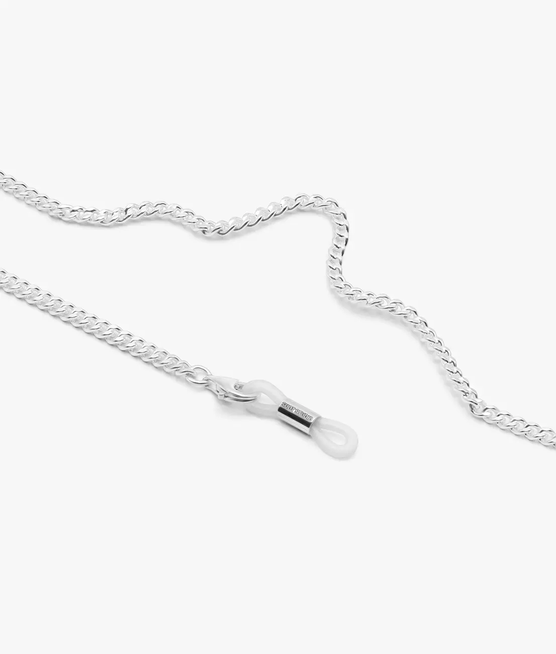 A fine silver curb-chain eyewear chain with a clear silicone loop · Jewellery photography, TimeLäB Studio Barcelona