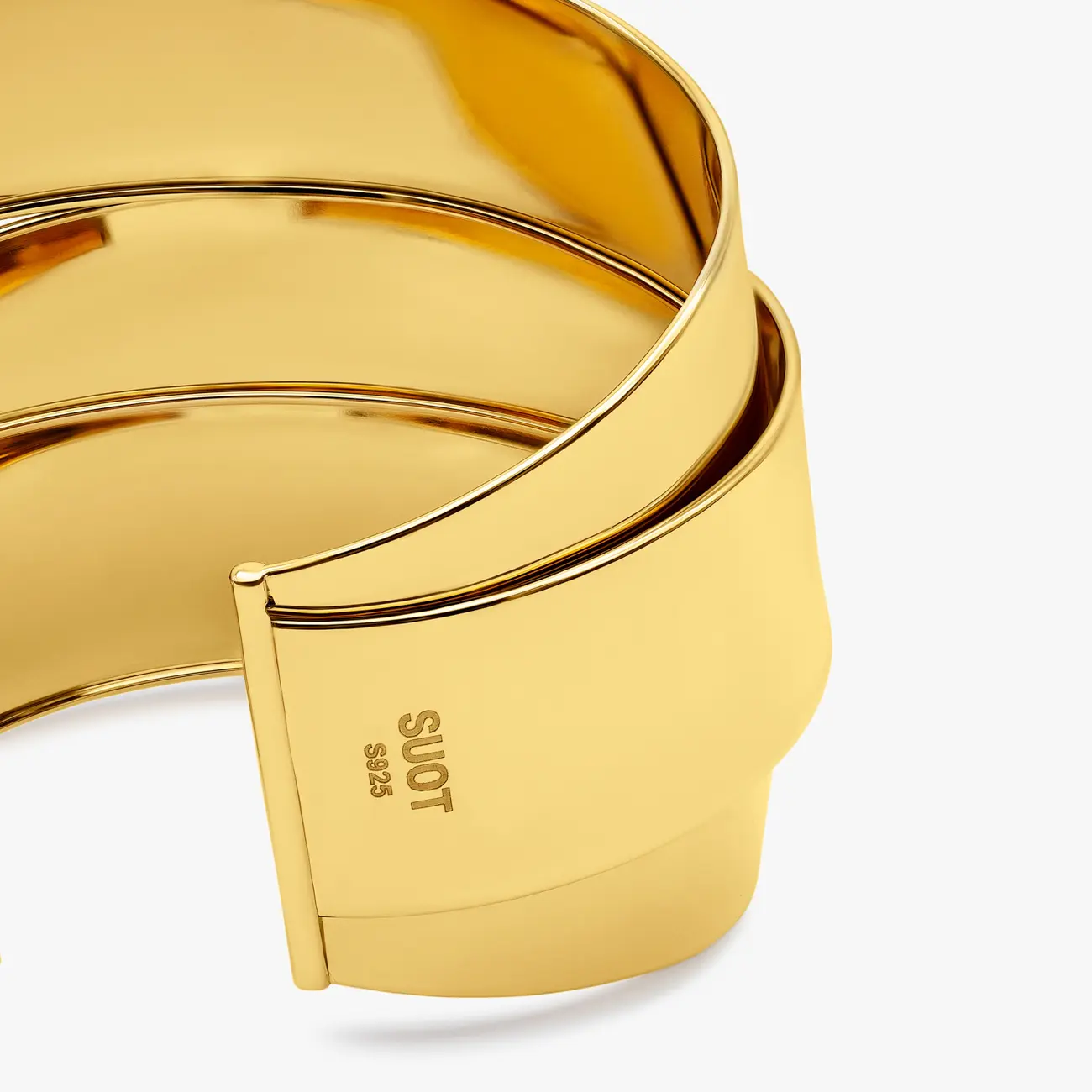 Two wide polished Tous cuff bangles in gold, the S925 hallmark in view · Jewellery photography, TimeLäB Studio Barcelona