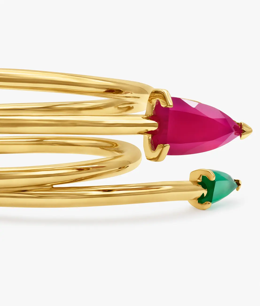 A coiled gold bangle tipped with fuchsia and green faceted stones · Jewellery photography, TimeLäB Studio Barcelona