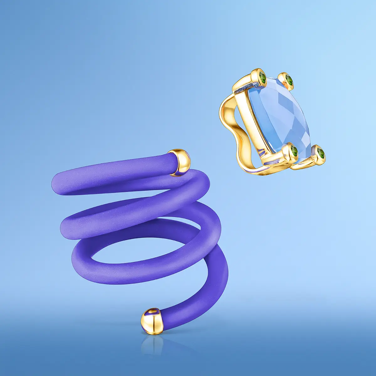 Coiled purple ring with a faceted blue stone, on blue · Jewellery photography, TimeLäB Studio Barcelona