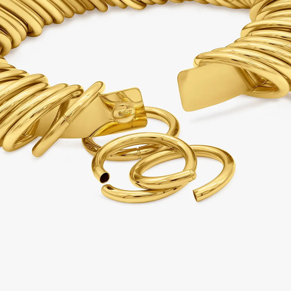 Gold cuff bracelets and rings arranged together · Jewellery photography, TimeLäB Studio Barcelona
