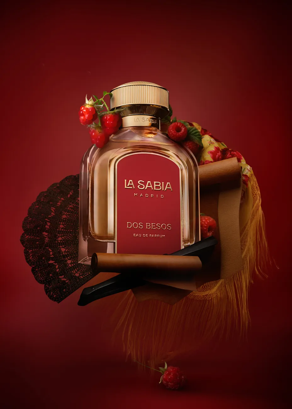 A red-toned fragrance styled with strawberries and a folding fan · Product photography, TimeLäB Studio Barcelona