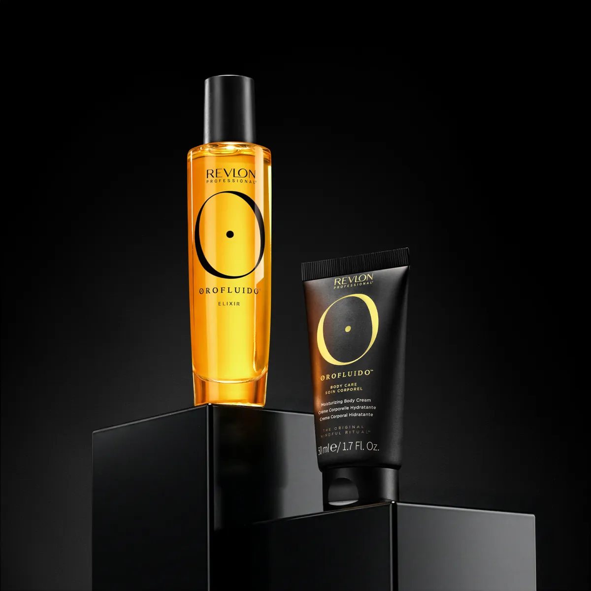 A gold hair-oil bottle and tube on a black plinth · Product photography, TimeLäB Studio Barcelona