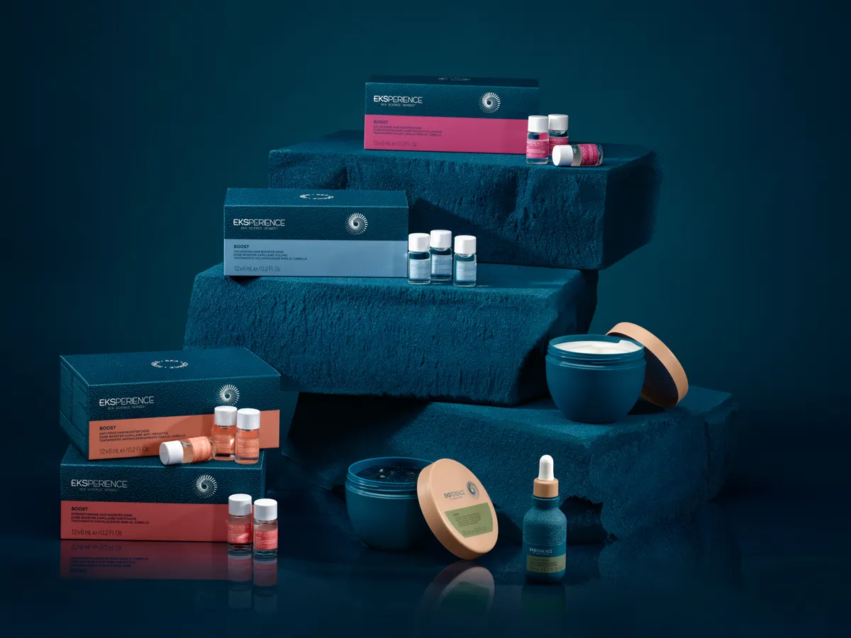 A skincare range boxed on deep-blue fabric · Product photography, TimeLäB Studio Barcelona