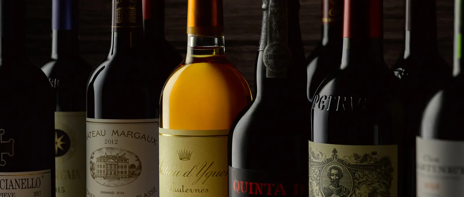 A line-up of wine bottles against deep shadow · Product photography, TimeLäB Studio Barcelona