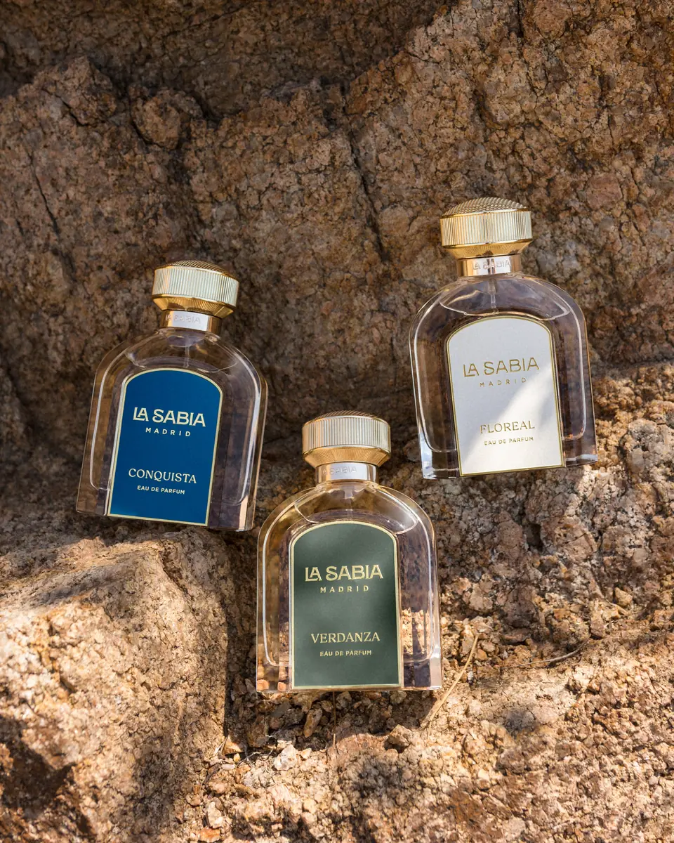 Three fragrances resting on a sunlit rock face · TimeLäB Studio