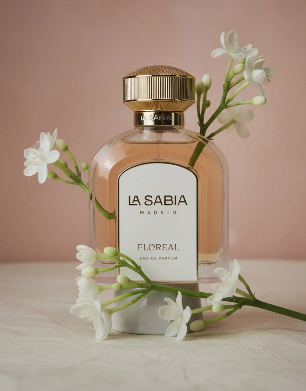 A fragrance framed by sprigs of white blossom · TimeLäB Studio