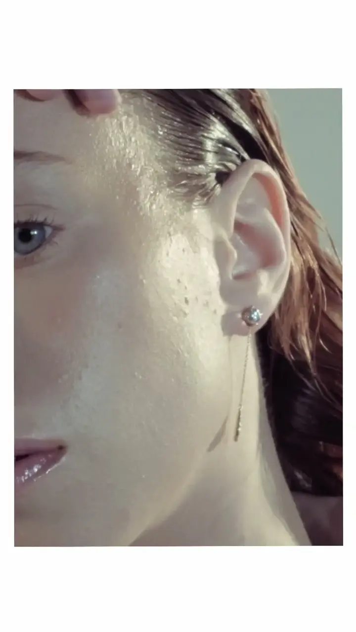 A gold earring against the skin